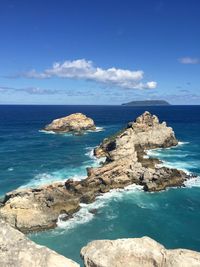 Scenic view of sea against blue sky