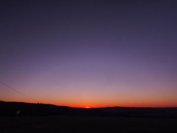 Scenic view of silhouette landscape against clear sky at sunset