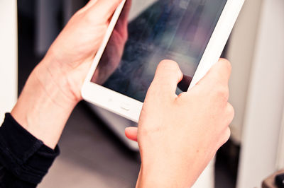 Cropped image of hands using digital tablet