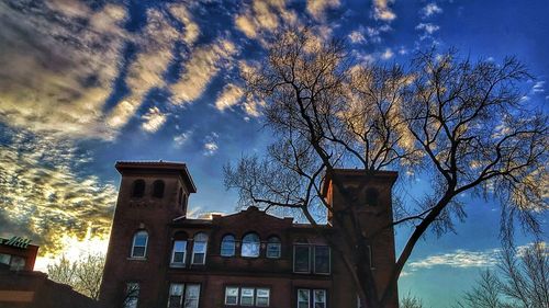 Low angle view of building against cloudy sky