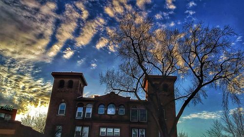 Low angle view of building against cloudy sky