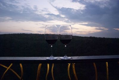 Close-up of wineglass against sky