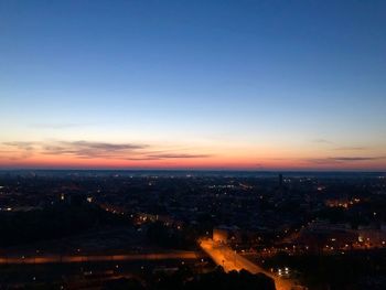 High angle view of illuminated buildings against sky during sunset