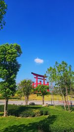 Gazebo on field against clear blue sky