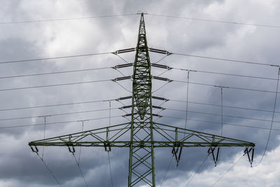 Low angle view of electricity pylon against sky