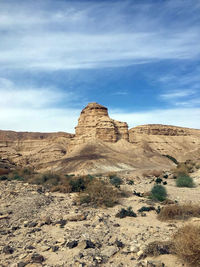 Rock formations on landscape against sky