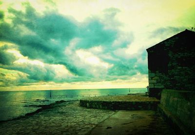 Scenic view of sea against cloudy sky