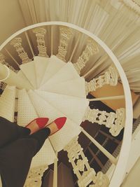 Low angle view of person holding spiral staircase