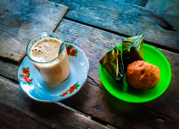 High angle view of coffee and cups on table