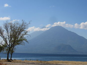 Scenic view of sea and mountains against sky