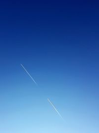 Low angle view of vapor trails in sky