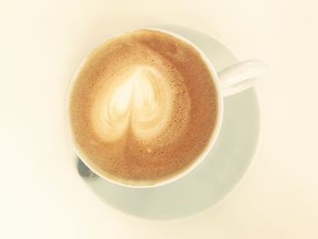 Close-up of coffee cup over white background