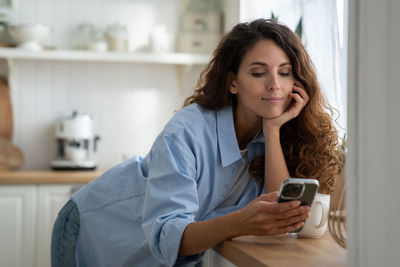 Young woman using phone