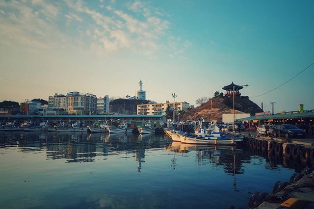 water, nautical vessel, moored, transportation, architecture, built structure, building exterior, mode of transport, harbor, boat, waterfront, sky, reflection, river, city, canal, outdoors, no people, day, travel