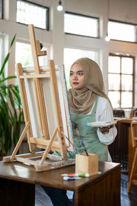 Young woman using laptop at table