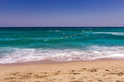 Scenic view of sea against clear blue sky