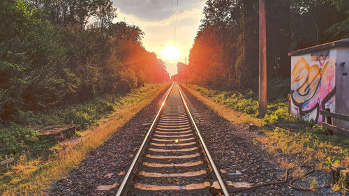 View of railroad tracks against sky during sunset
