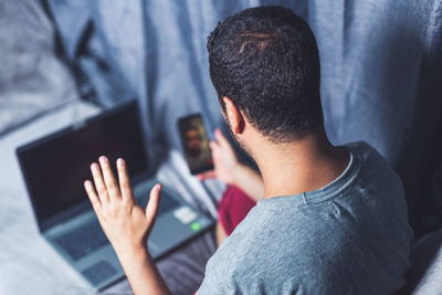 High angle view of man video calling at home