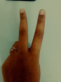 Close-up of hand against gray background