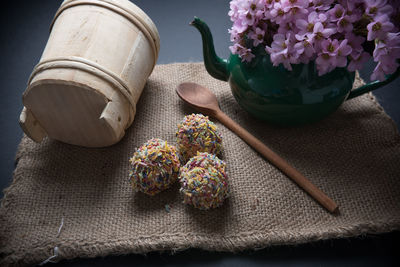 High angle view of sweet food with flowers on burlap