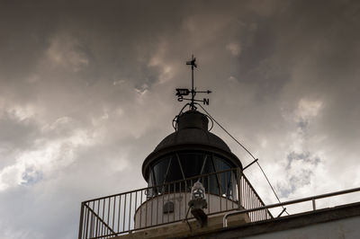 Low angle view of man against cloudy sky