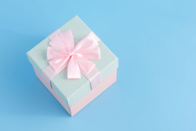 High angle view of gift box on blue background