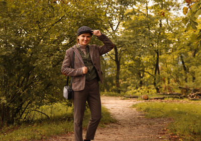 Woman wearing in british or english style clothes. masculine woman. young smiling woman wearing hat