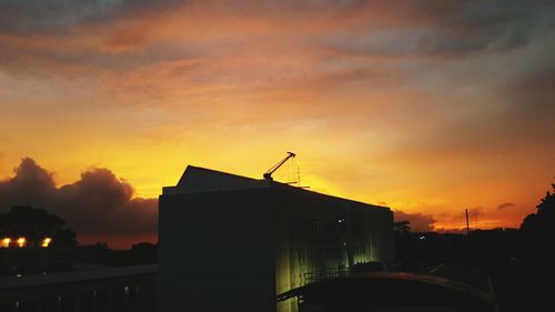 Low angle view of silhouette building against sky during sunset