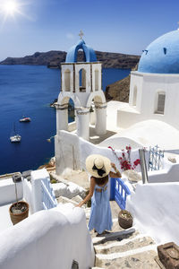 Rear view of woman standing on steps outdoors