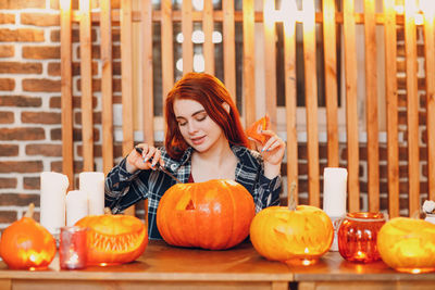 Portrait of young woman holding pumpkin