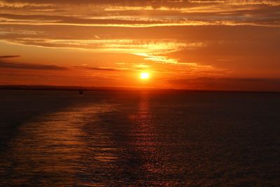 Scenic view of sea against romantic sky at sunset