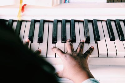 Cropped image of girl playing piano