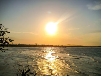 Scenic view of beach against sky during sunset