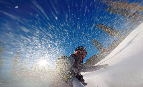 Low angle view of man against blue sky