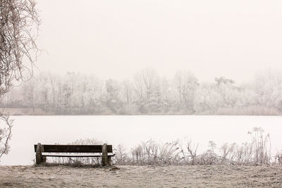 Scenic view of lake against clear sky during winter