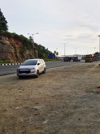 Cars on road against sky