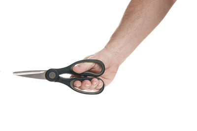 Close-up of hand holding eyeglasses against white background