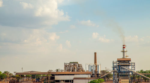 Factory against sky in city