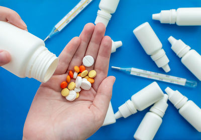 Cropped hand of person holding pills