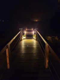 Illuminated bridge against sky at night