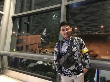 Portrait of smiling young man standing at night