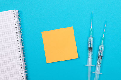 Close-up of paper over blue background