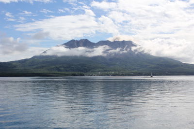 Scenic view of sea and mountains against sky