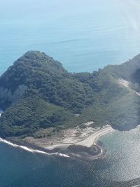 High angle view of land and sea against sky