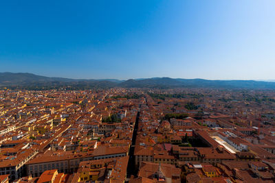 High angle view of townscape against clear blue sky