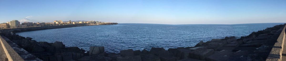 Panoramic view of sea and buildings against sky