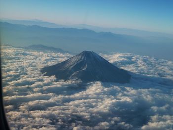 Aerial view of snowcapped mountains against sky