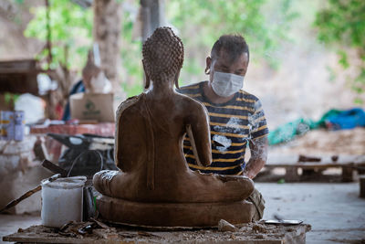Statue of buddha against temple