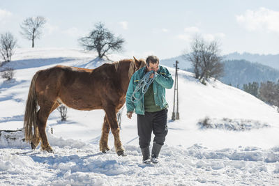 Full length of horse standing on snow covered land