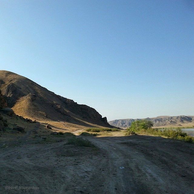 clear sky, copy space, tranquility, tranquil scene, mountain, blue, landscape, scenics, beauty in nature, road, nature, non-urban scene, the way forward, remote, day, outdoors, no people, mountain range, idyllic, countryside